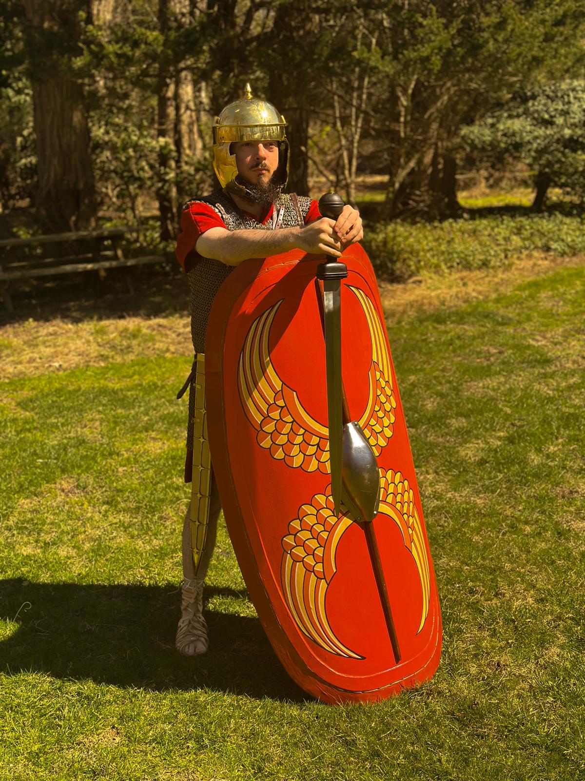 A late Republic Roman legionary leaning on his shield, sword dangling in front of him, staring ahead